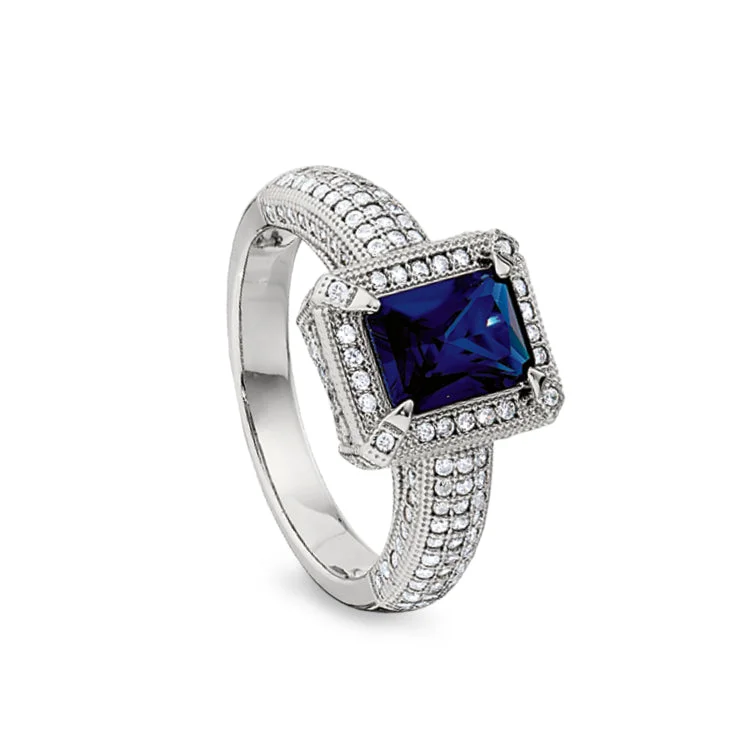 Platinum Finish Sterling Silver Micropave Emerald Cut Synthetic Blue Sapphire Ring with Simulated Diamonds